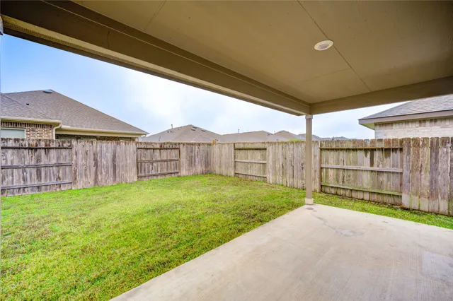 a view of an house with backyard space and balcony