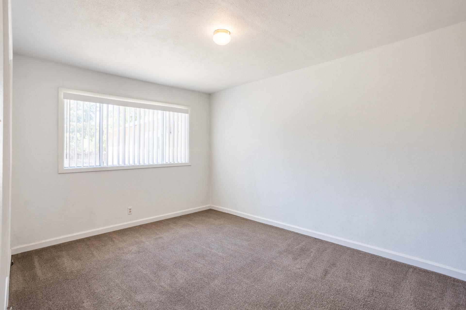 1105 5th Street Redding, CA 96002 - Photo 8 of 11 an empty room with a window