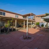 a view of a house with backyard porch and sitting area
