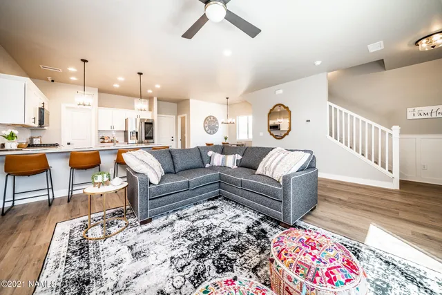 a kitchen with stainless steel appliances granite countertop a sink dishwasher a stove a refrigerator with a dining table and chairs