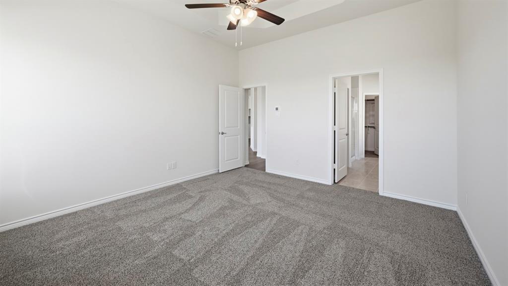 4163 Waldron Trail Forney, TX 75126 - Photo 27 of 30 Carpeted interior room with white walls, baseboards, and a ceiling fan