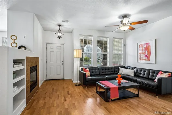 a living room with furniture and a fireplace