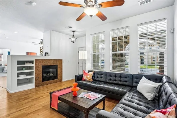 a dining room with wooden floor a chandelier a wooden table and chairs