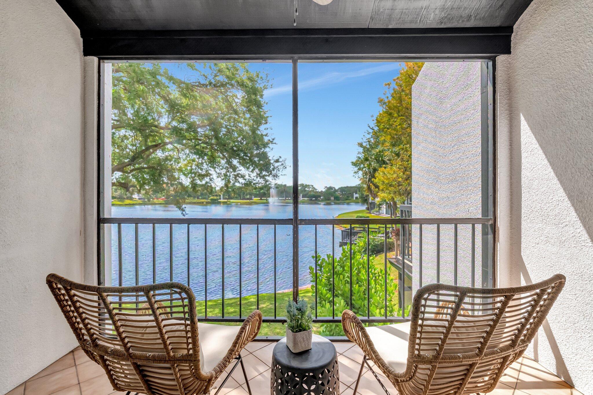 a balcony with furniture and potted plants
