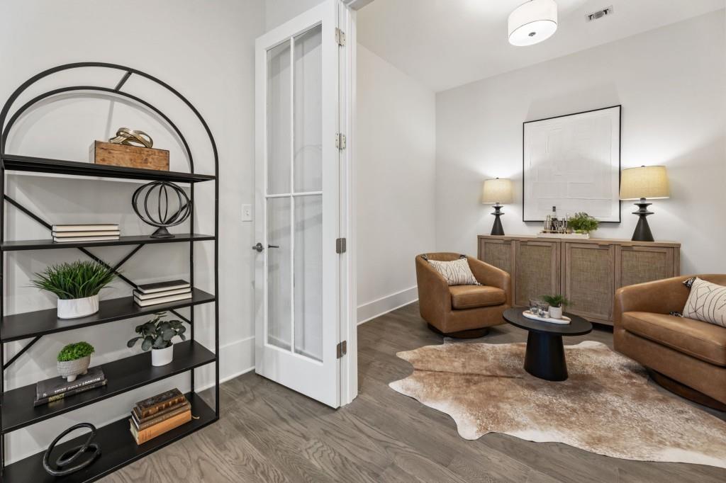 12455 Broadwell Road, Unit 201 Milton, GA 30004 - Photo 12 of 38 a living room with furniture a flat screen tv and a window