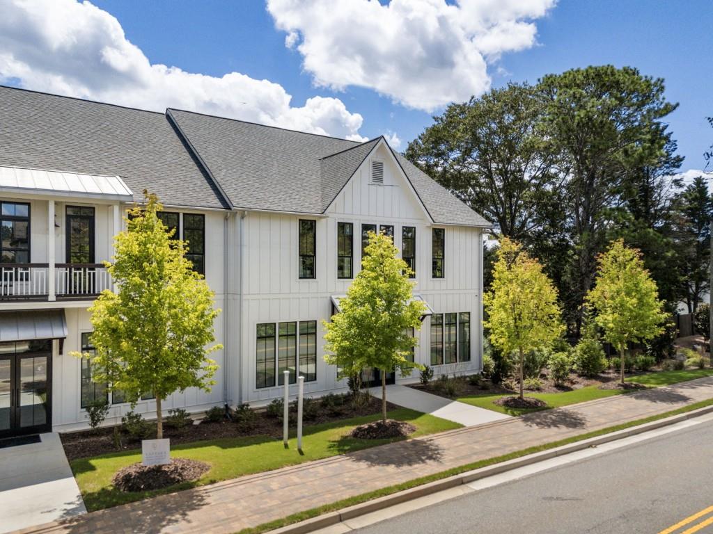 12455 Broadwell Road, Unit 201 Milton, GA 30004 - Photo 2 of 38 a front view of a house with garden