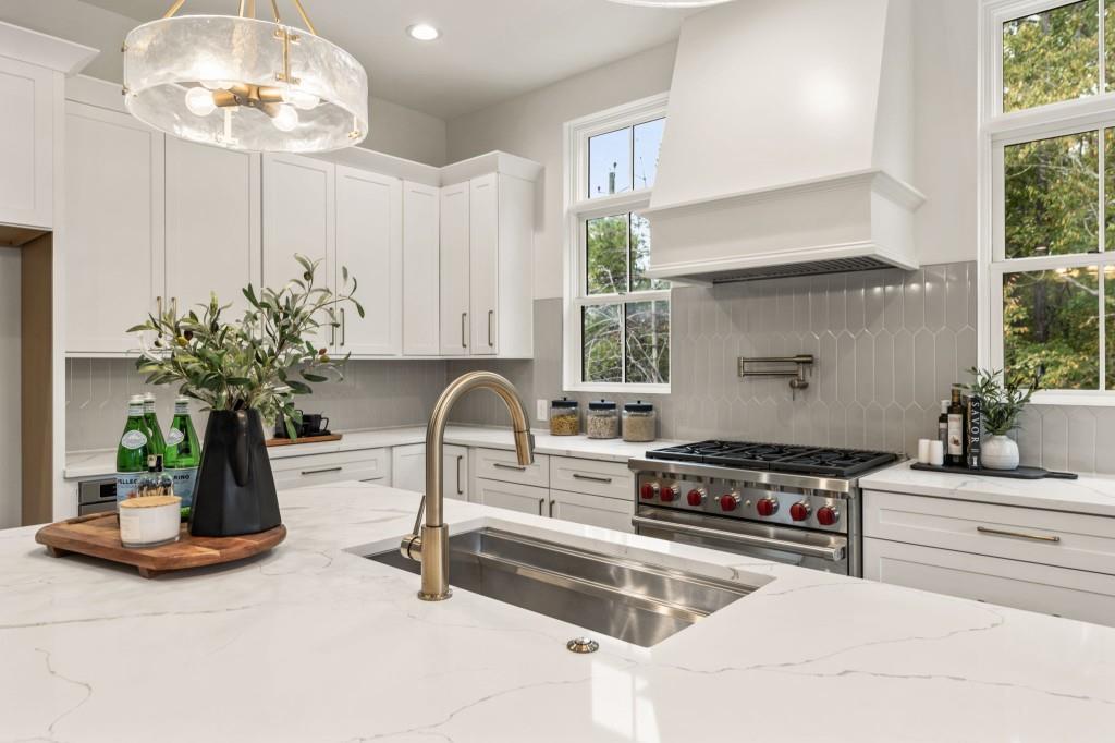 12455 Broadwell Road, Unit 201 Milton, GA 30004 - Photo 21 of 38 a kitchen with stainless steel appliances a counter space a sink a window and cabinets