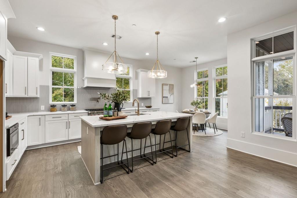 12455 Broadwell Road, Unit 201 Milton, GA 30004 - Photo 3 of 38 a kitchen with center island table and chairs