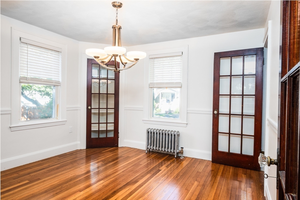 10 Weston Street Milton, MA 02186 - Photo 12 of 35 a view of empty room with wooden floor and windows