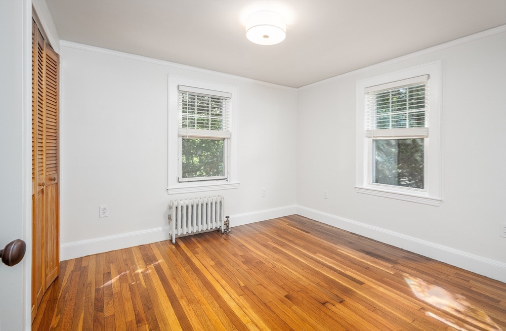 10 Weston Street Milton, MA 02186 - Photo 20 of 35 a view of an empty room with wooden floor and a window