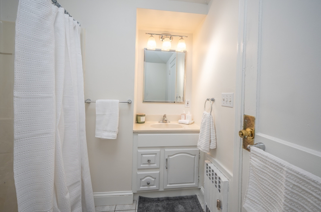 10 Weston Street Milton, MA 02186 - Photo 21 of 35 a bathroom with a sink a toilet and mirror