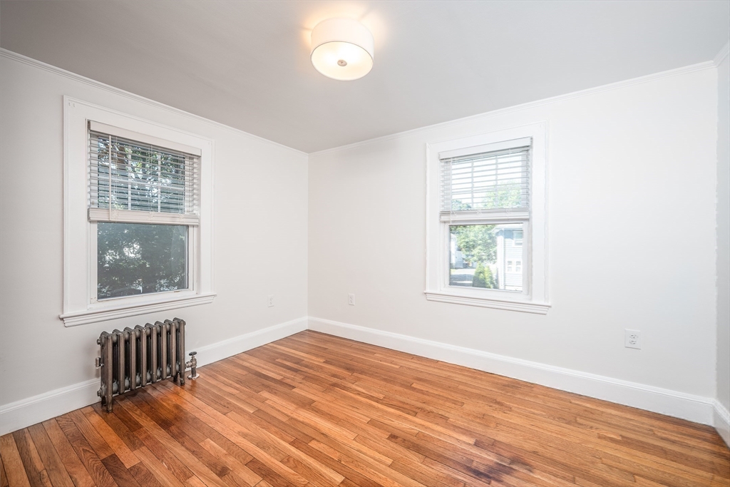 10 Weston Street Milton, MA 02186 - Photo 24 of 35 an empty room with wooden floor and windows