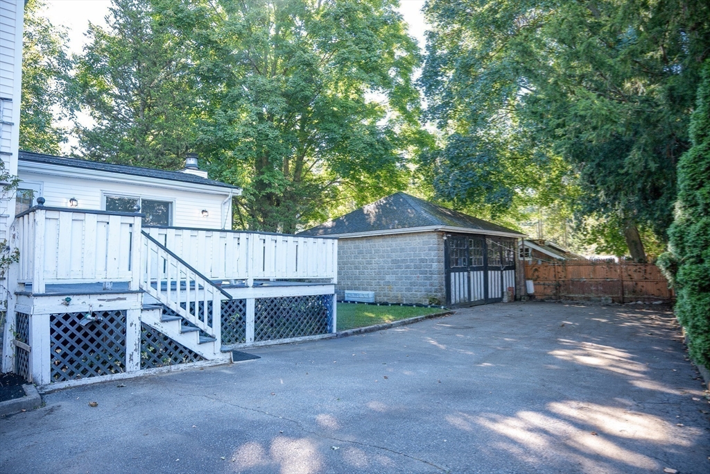 10 Weston Street Milton, MA 02186 - Photo 29 of 35 a view of backyard with white fence and a large tree