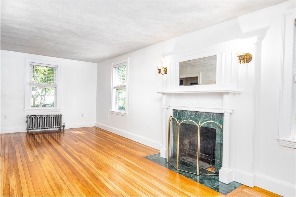 10 Weston Street Milton, MA 02186 - Photo 9 of 35 a view of a livingroom with a fireplace and window