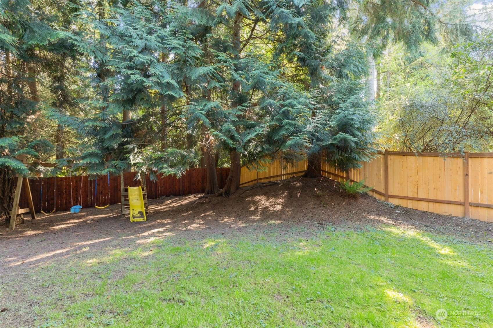 2330 243rd Place Southeast Bothell, WA 98021 - Photo 36 of 40 a view of a backyard with a tree and wooden fence