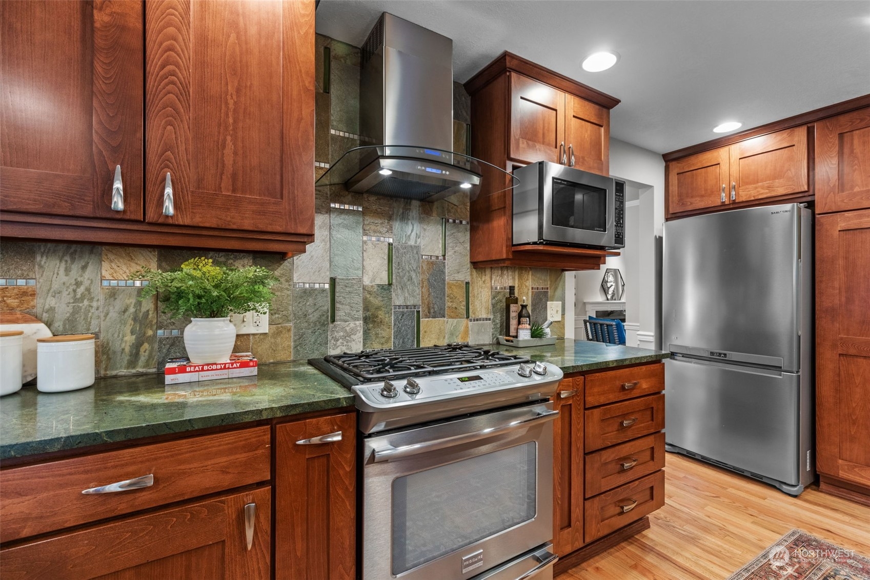 2330 243rd Place Southeast Bothell, WA 98021 - Photo 8 of 40 a kitchen with stainless steel appliances granite countertop a refrigerator stove and sink
