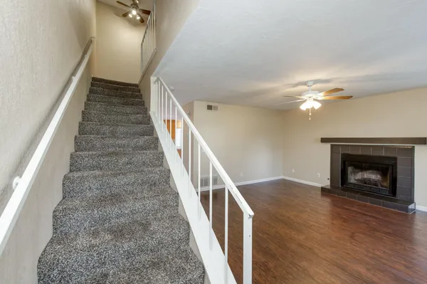 a view of a hallway with a livingroom and a bathroom
