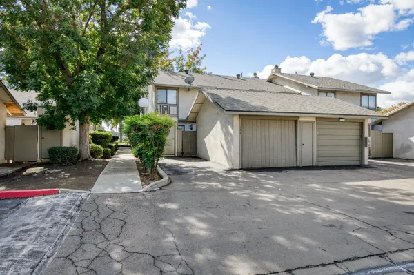 a view of a house with a yard and garage