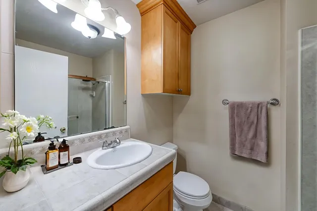 a bathroom with a glass shower door