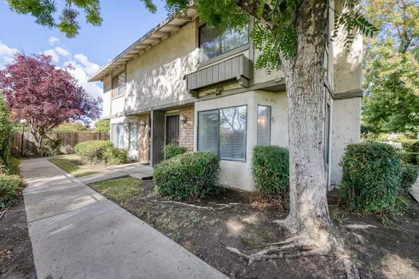 a view of a house with a tree