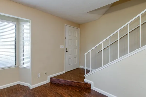 a living room with stairs and a window