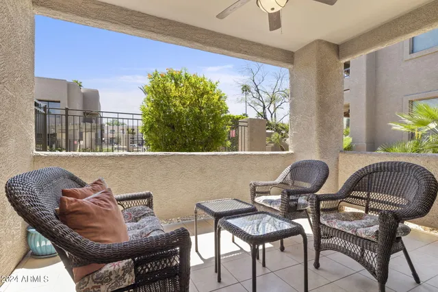 a living room with furniture and a potted plant