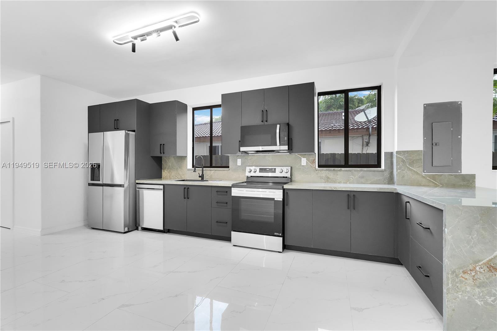 972 Southwest 44th Avenue Miami, FL 33134 - Photo 24 of 53 a kitchen with stainless steel appliances a refrigerator a sink a stove a microwave and cabinets