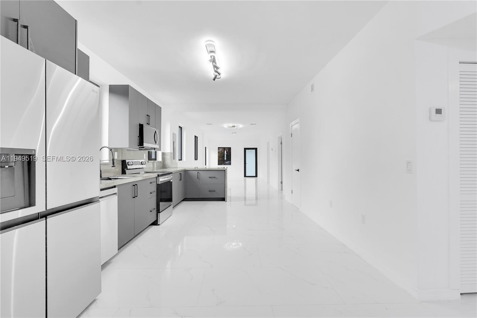 972 Southwest 44th Avenue Miami, FL 33134 - Photo 28 of 53 a large white kitchen with granite countertop a sink stainless steel appliances and cabinets