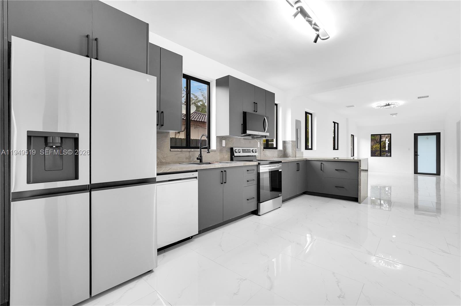 972 Southwest 44th Avenue Miami, FL 33134 - Photo 29 of 53 a kitchen with stainless steel appliances a refrigerator sink and cabinets