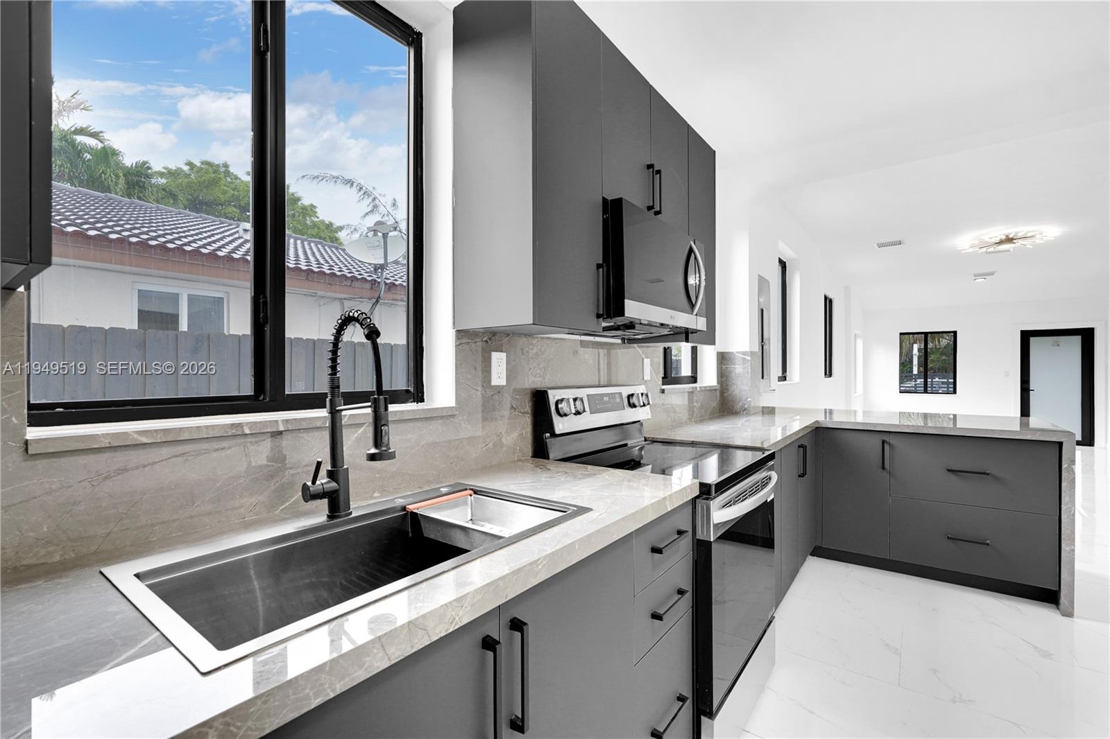 972 Southwest 44th Avenue Miami, FL 33134 - Photo 30 of 53 a kitchen with granite countertop a sink and cabinets