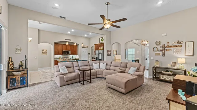 a kitchen with granite countertop a refrigerator stove microwave and cabinets