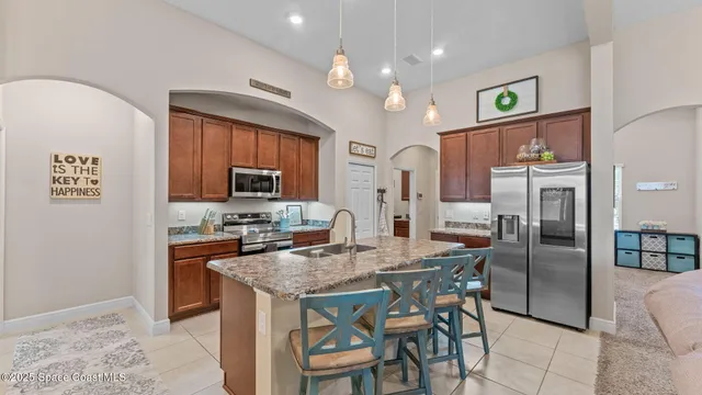 a kitchen with a granite countertop sink and a mirror