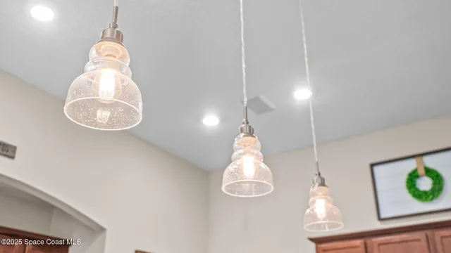 a bedroom with a bed and a flat tv screen on dresser