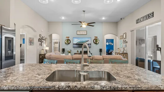 a bathroom with a granite countertop double vanity sink mirror and shower