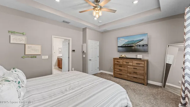 a white vase with white and yellow flowers