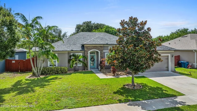 a view of a hallway with windows and chandelier