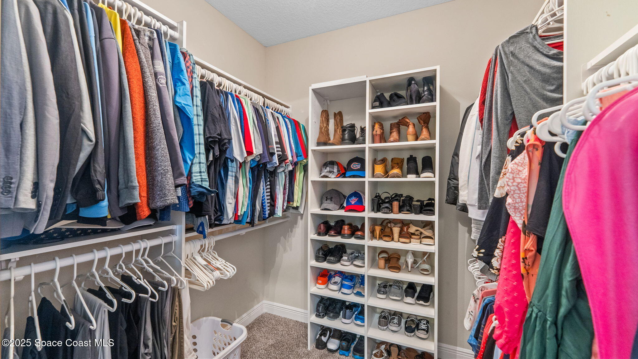 1106 Morgan Circle Northeast Palm Bay, FL 32905 - Photo 31 of 53 a view of walk in closet with clothes and shoes