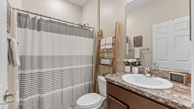 an aerial view of a house with a yard basket ball court and outdoor seating