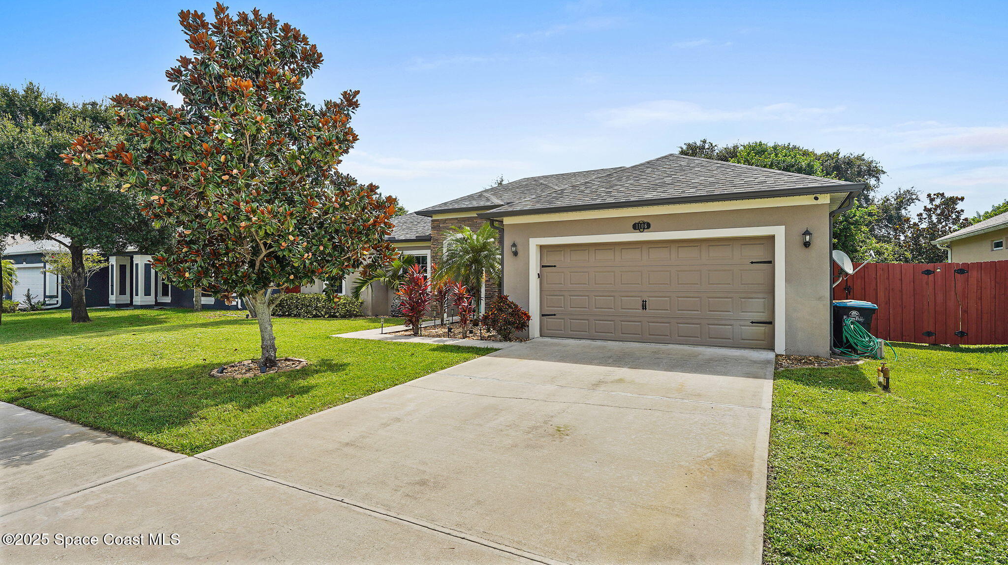 1106 Morgan Circle Northeast Palm Bay, FL 32905 - Photo 4 of 53 a front view of a house with a yard and garage