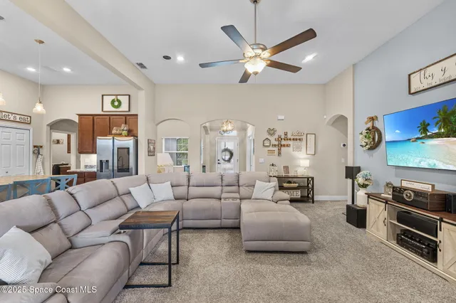 a kitchen with granite countertop a table chairs microwave and refrigerator