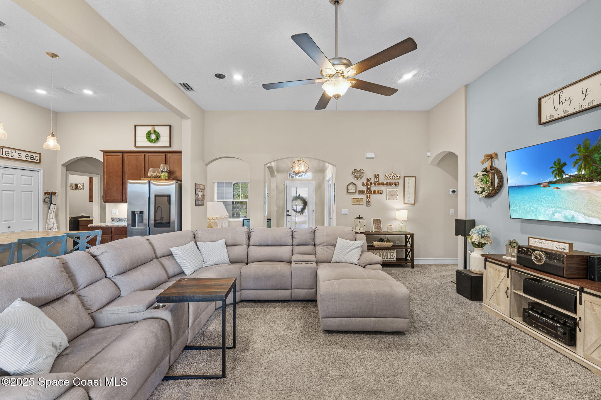 1106 Morgan Circle Northeast Palm Bay, FL 32905 - Photo 10 of 53 a living room with furniture kitchen view and a chandelier