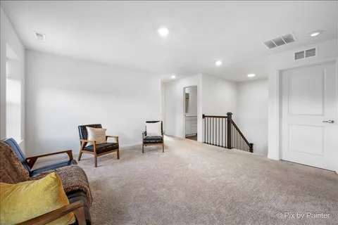 a spacious bedroom with a bed and a flat screen tv