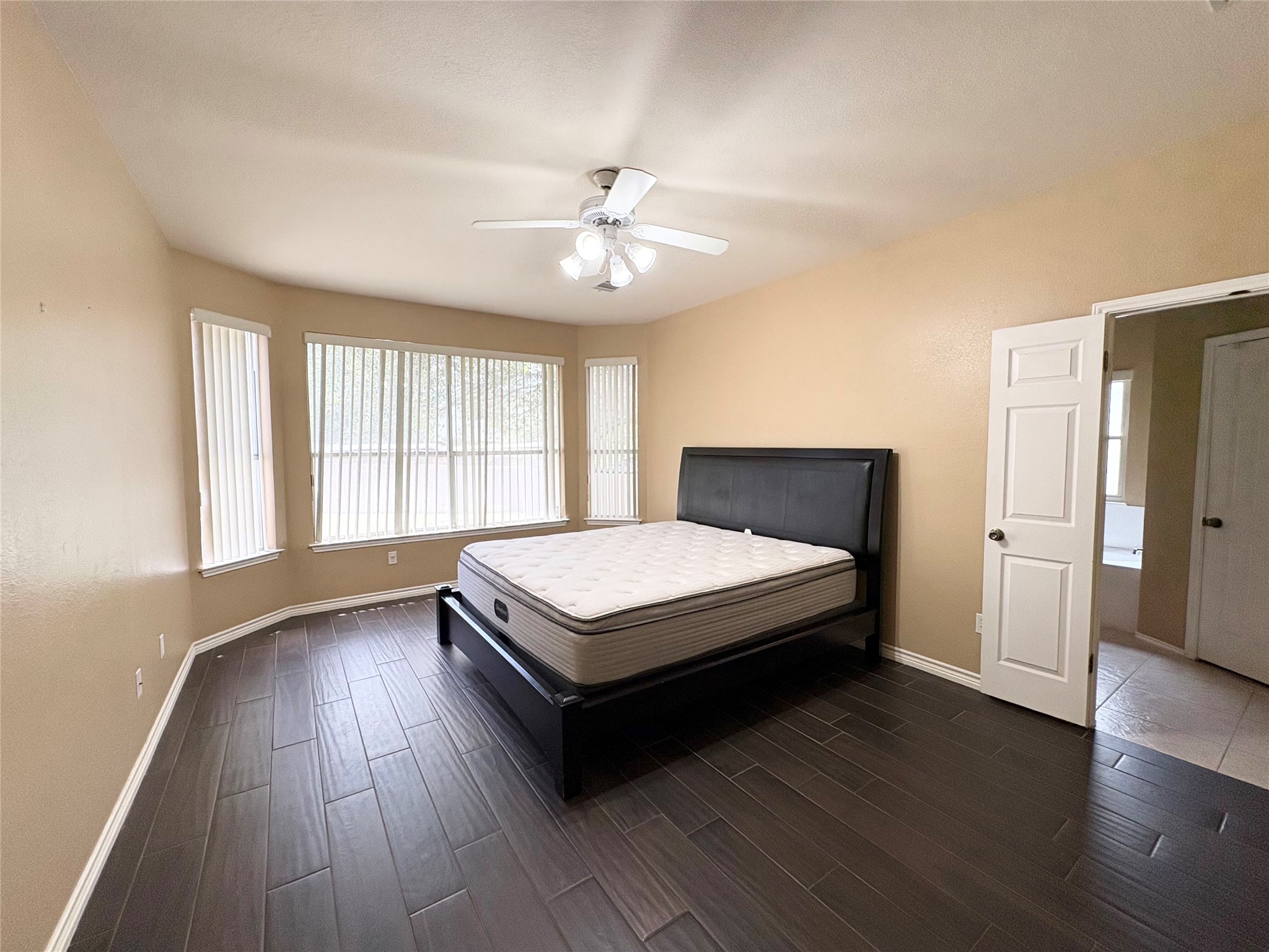 8103 Ephraim Road Austin, TX 78717 - Photo 17 of 35 Discover a spacious primary suite featuring beautiful dark wood flooring and ample natural light.