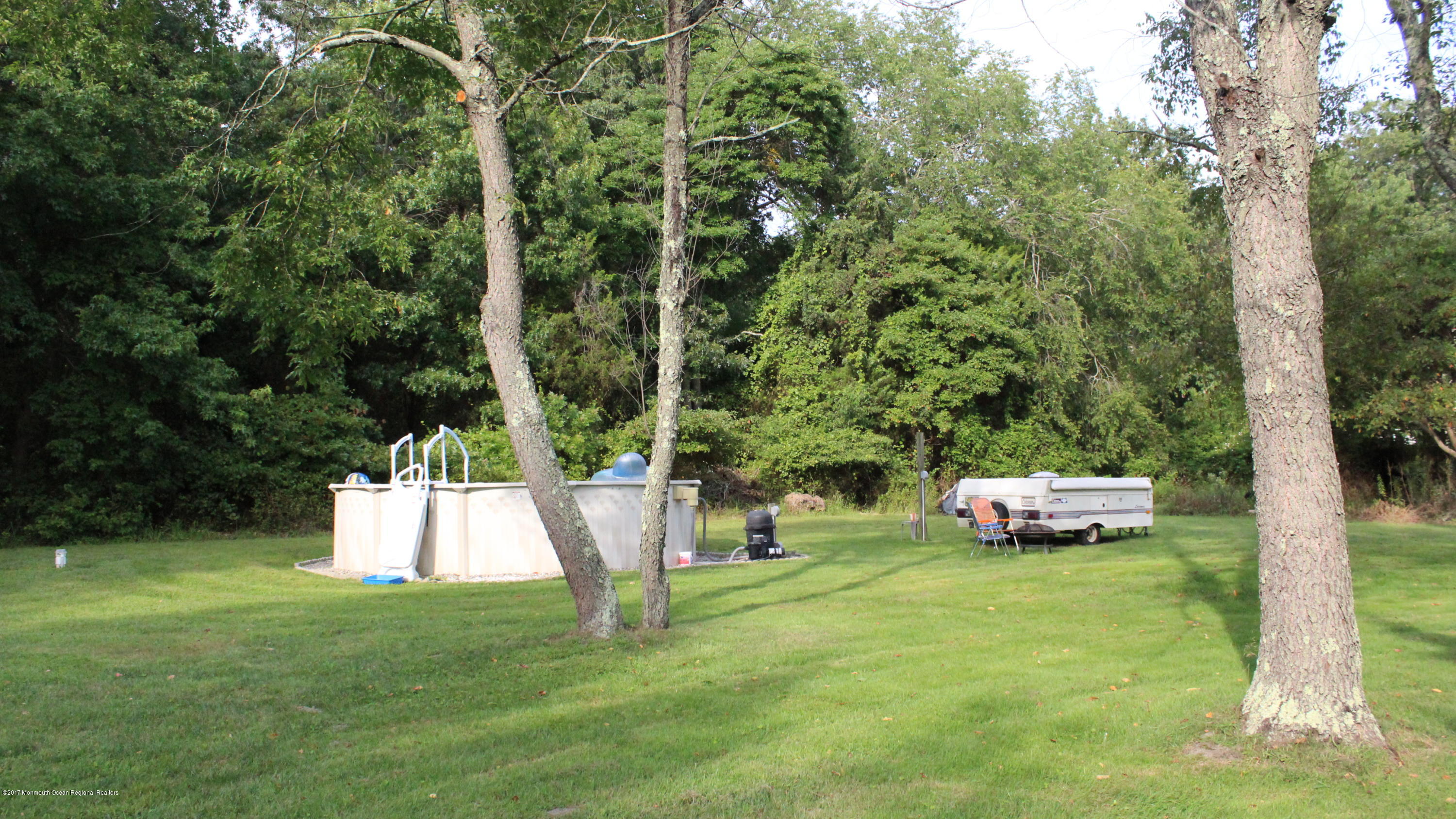 451 Pfister Road Jackson, NJ 08527 - Photo 20 of 25 a view of a backyard with a garden and trees