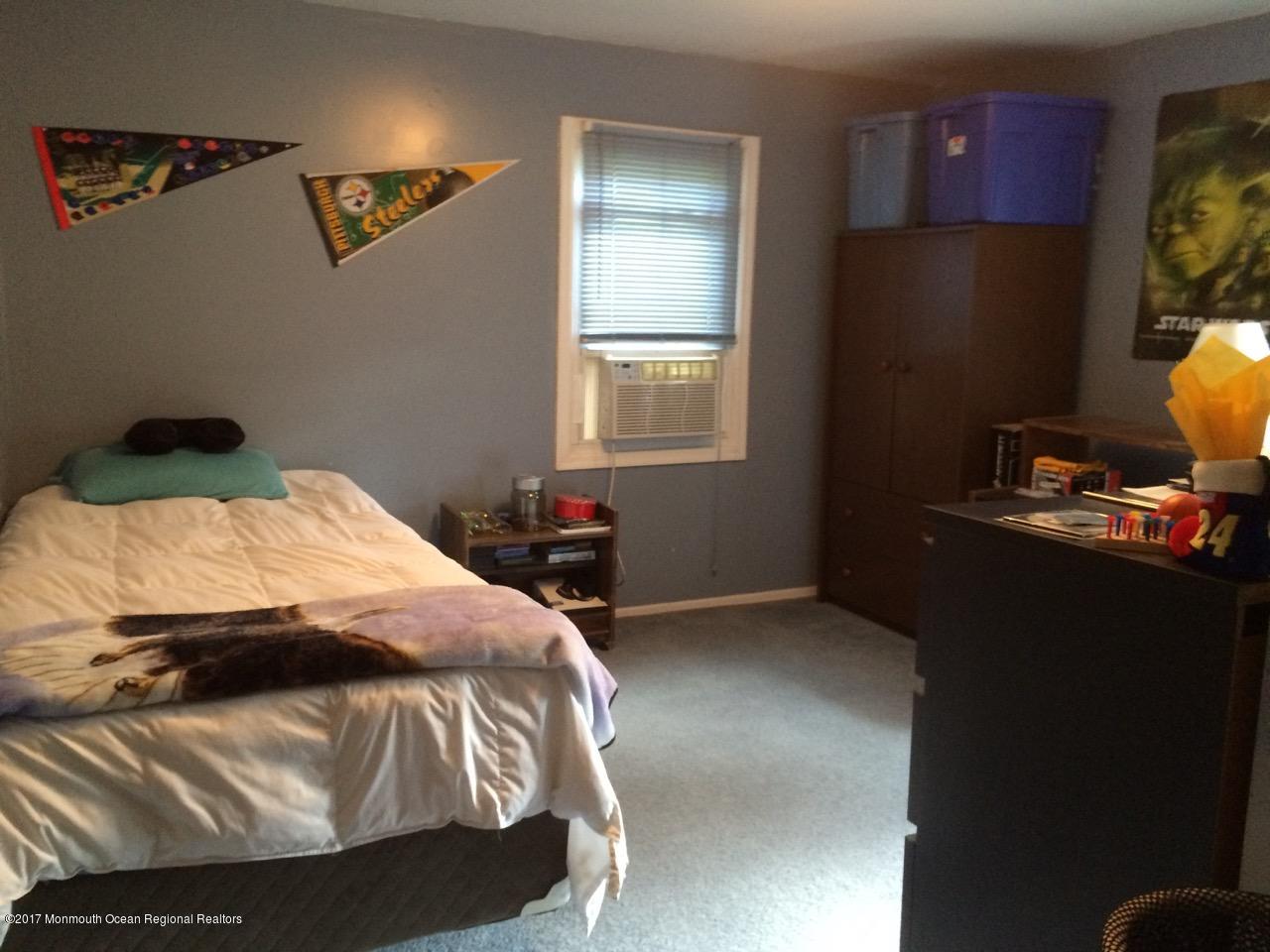 451 Pfister Road Jackson, NJ 08527 - Photo 8 of 25 a bedroom with a bed and a flat screen tv