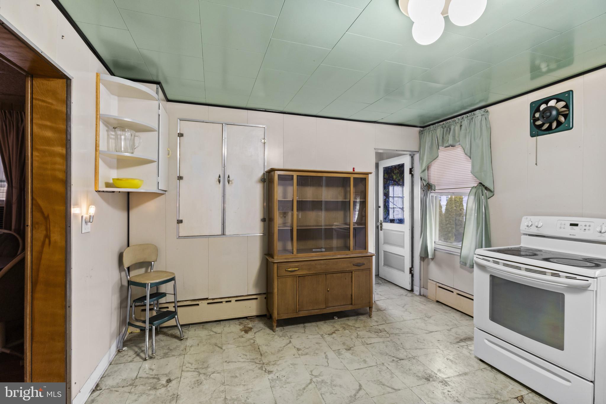7627 Carson Avenue Baltimore, MD 21224 - Photo 13 of 38 a kitchen with refrigerator and cabinets