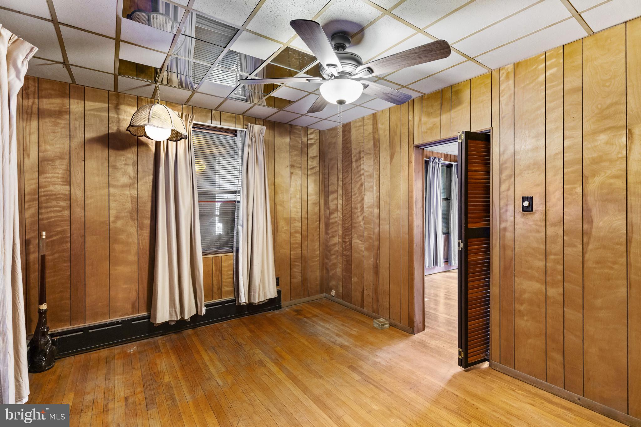 7627 Carson Avenue Baltimore, MD 21224 - Photo 15 of 38 an empty room with wooden floor and windows