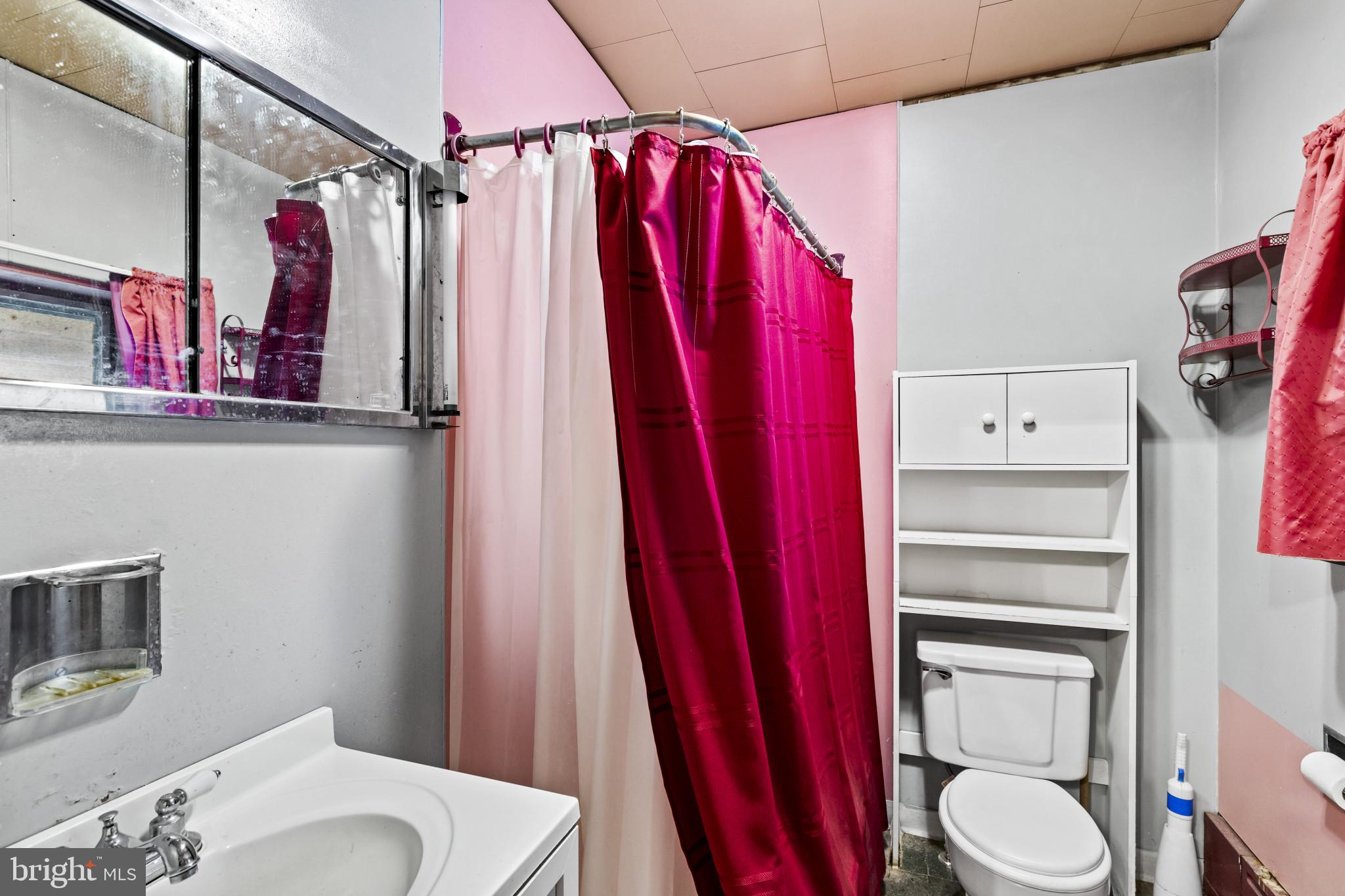 7627 Carson Avenue Baltimore, MD 21224 - Photo 18 of 38 a bathroom with a toilet a sink and tub