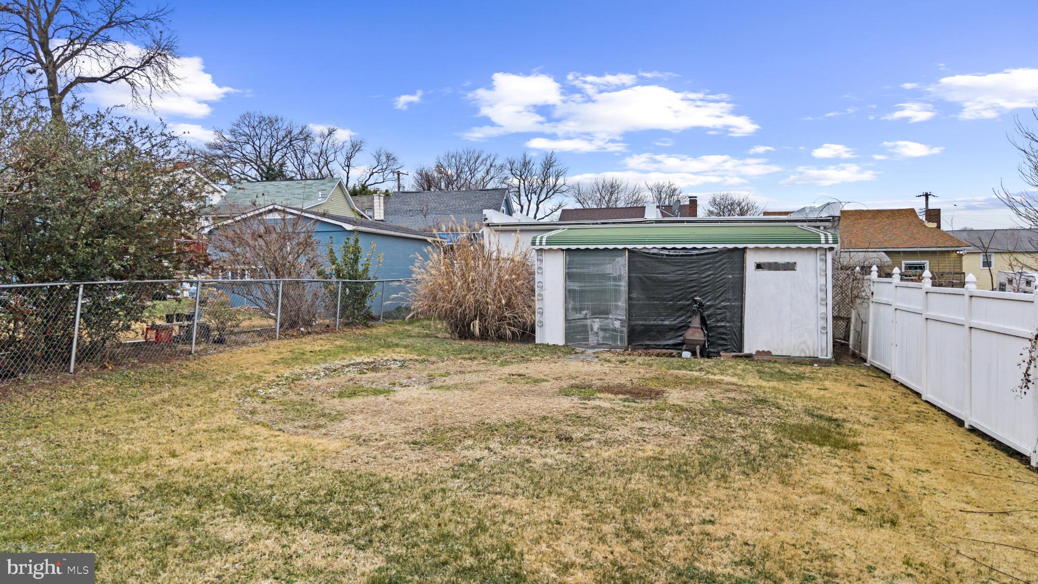 7627 Carson Avenue Baltimore, MD 21224 - Photo 30 of 38 a front view of a house with a yard and garage