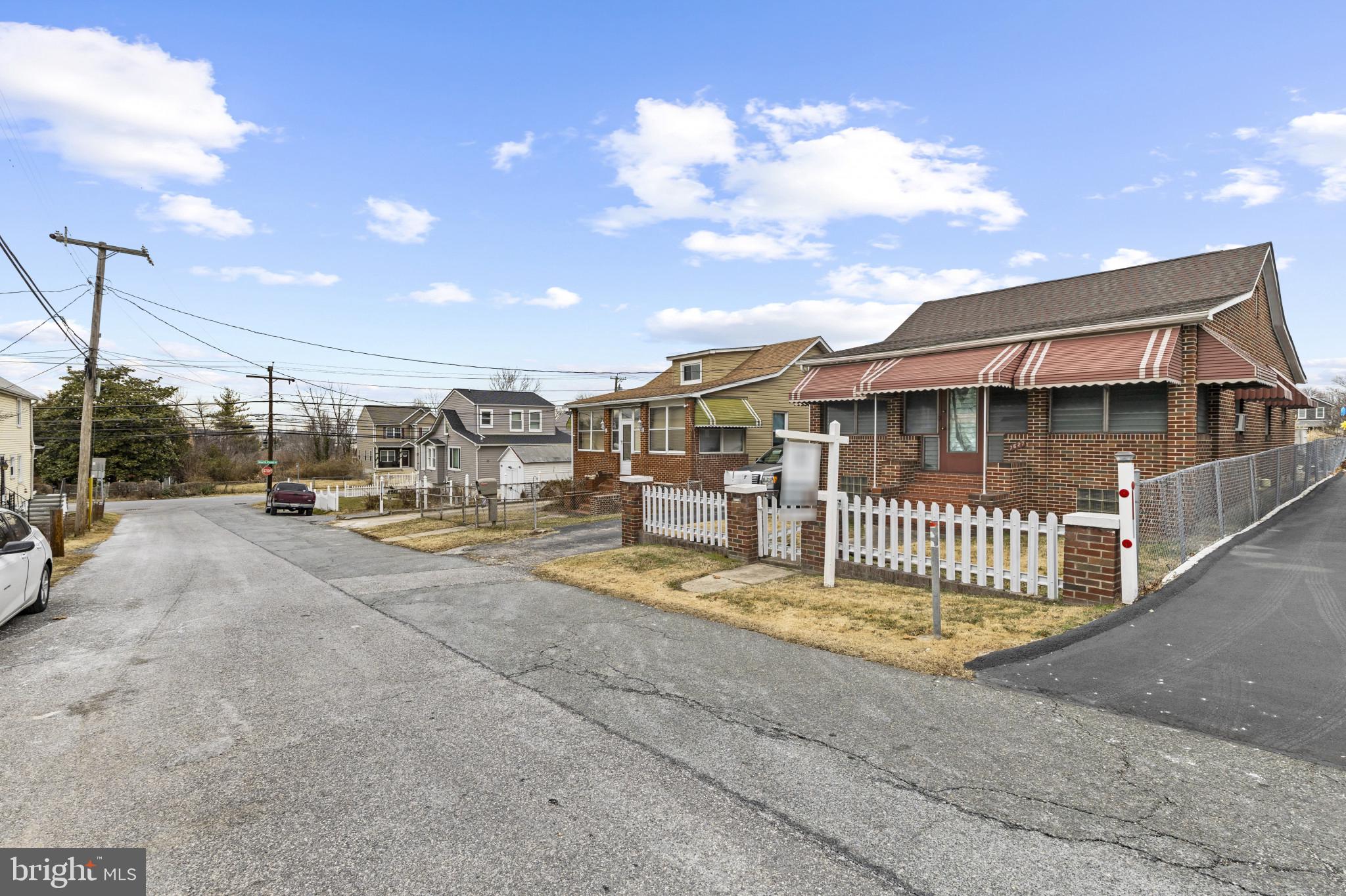 7627 Carson Avenue Baltimore, MD 21224 - Photo 8 of 38 a view of residential houses with cars parked